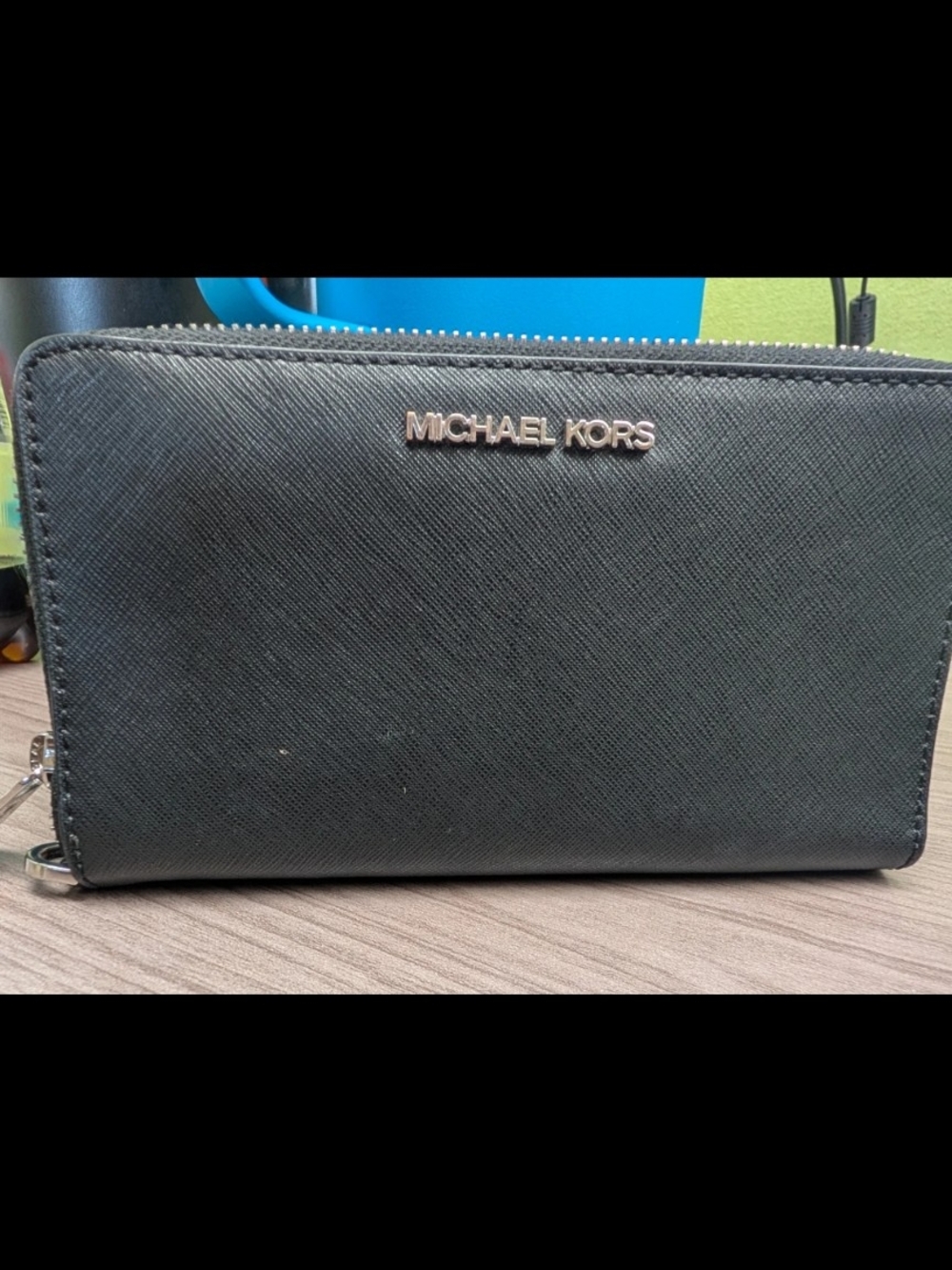 Michael Kors women's black saffiano leather zip wallet.